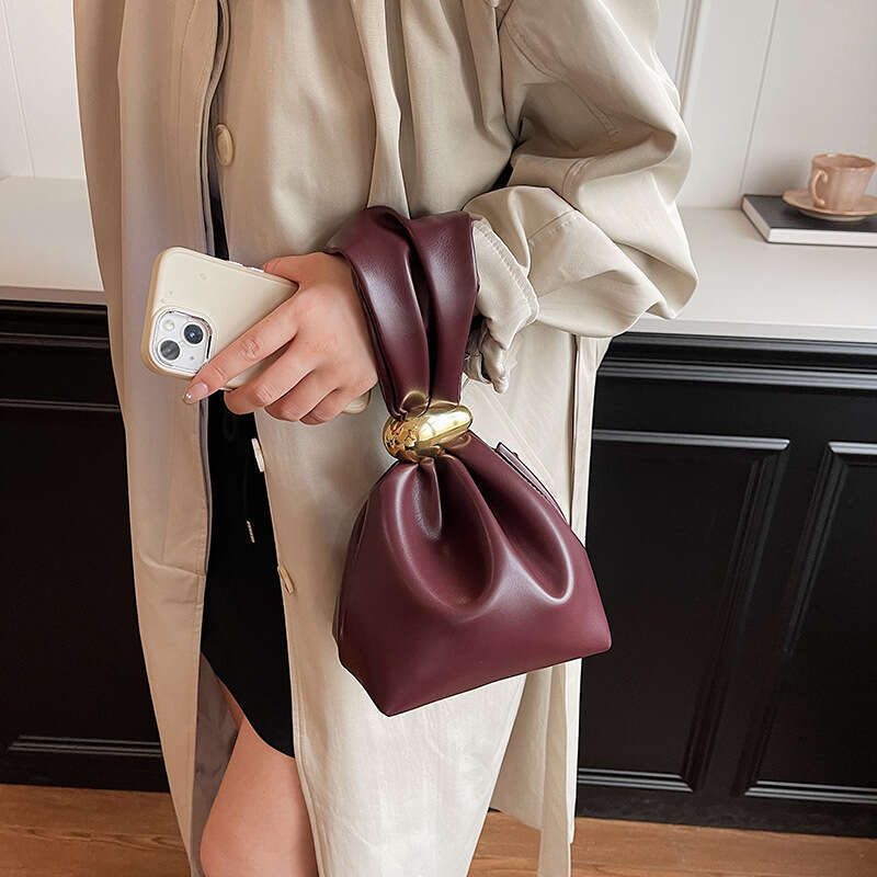 Small design, high grade women's unique mouth binding bucket lucky handbag, hot girl, hand held zi bag, 2024 new style, chic and elegant clothing