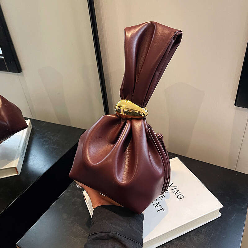 Small design, high grade women's unique mouth binding bucket lucky handbag, hot girl, hand held zi bag, 2024 new style, chic and elegant clothing