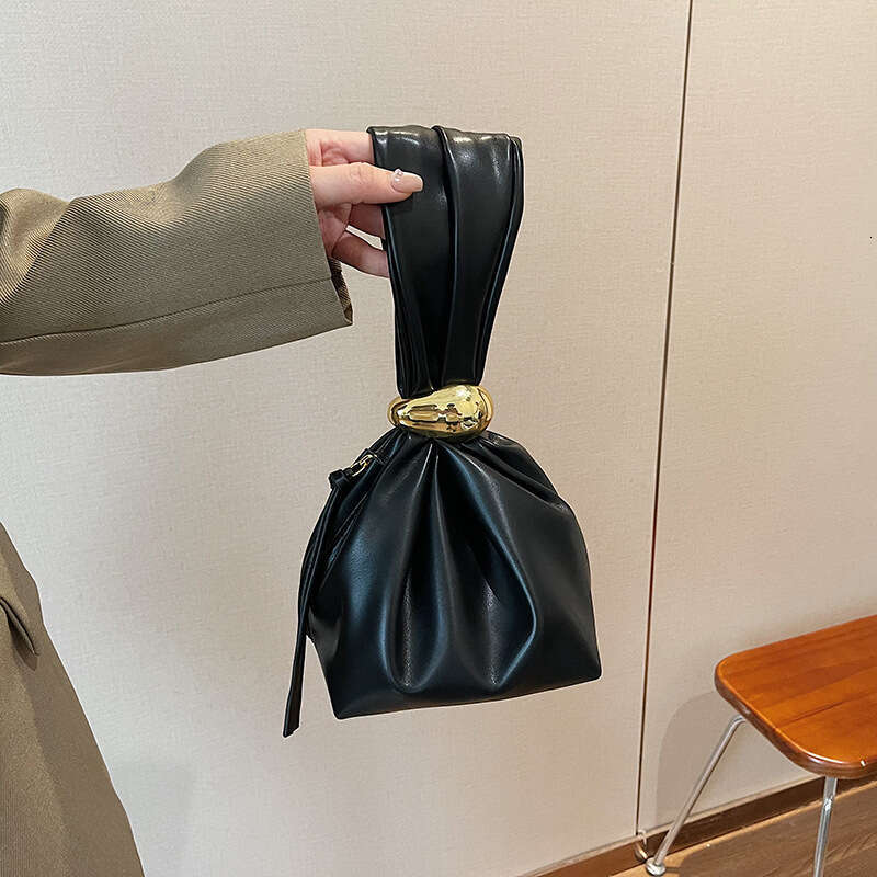 Small design, high grade women's unique mouth binding bucket lucky handbag, hot girl, hand held zi bag, 2024 new style, chic and elegant clothing