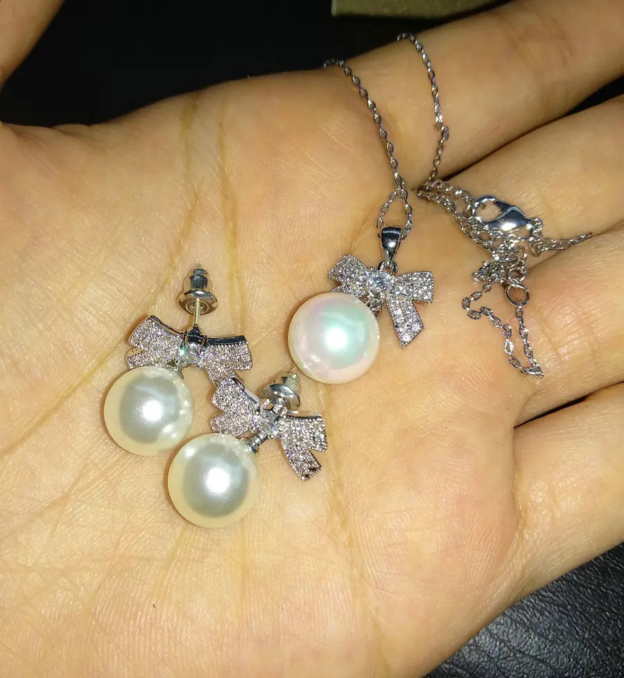 SINZRY Korean jewelry white color cubic zircon bowknot simulated pearl pendant necklace earring jewelry set christmas gift 241226