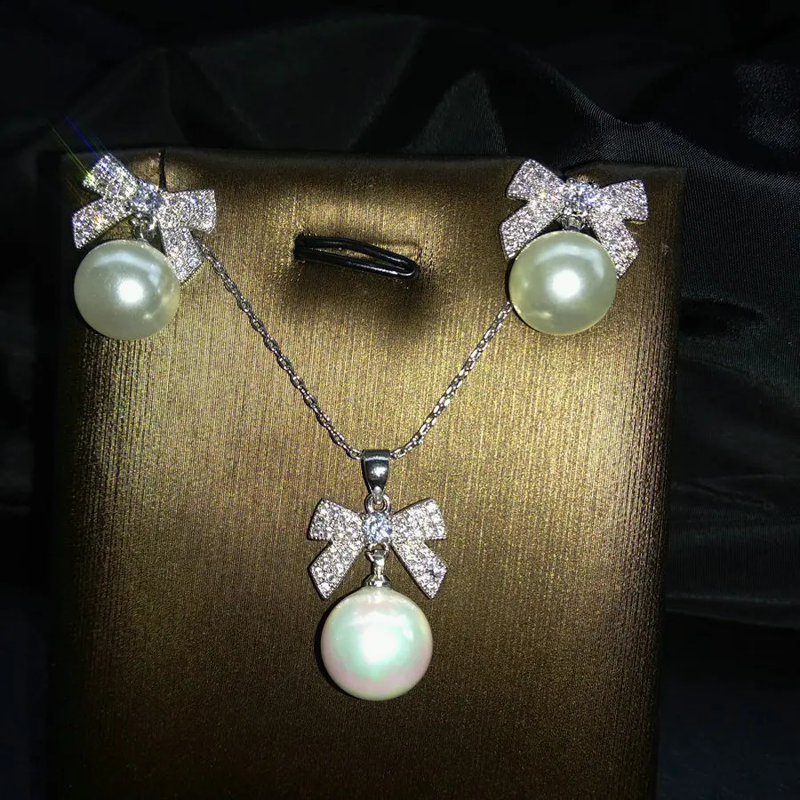 SINZRY Korean jewelry white color cubic zircon bowknot simulated pearl pendant necklace earring jewelry set christmas gift 241226