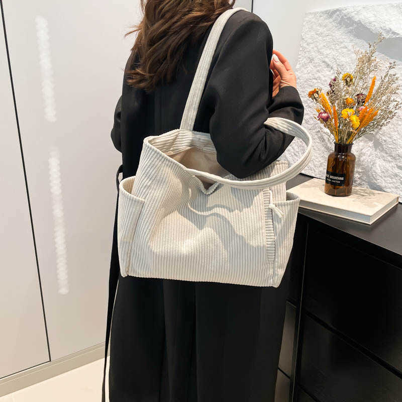 Casual Western style pendant with large capacity and simple 2024 solid color new trend, simple striped velvet hand-held shoulder tote bag for women 24