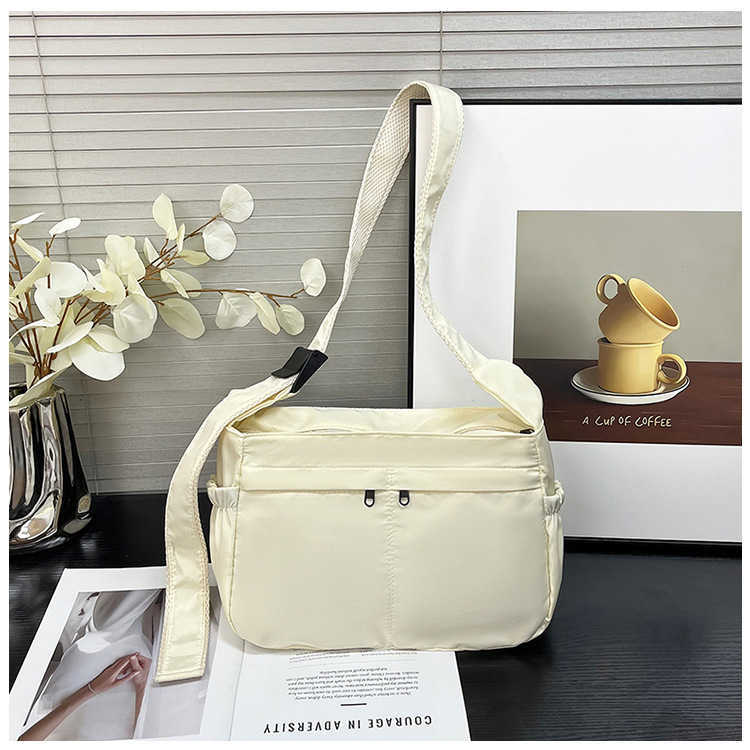 Large capacity single shoulder tote casual waterproof and stylish simple nylon fabric solid color lightweight sports dumpling tote women's bag 24