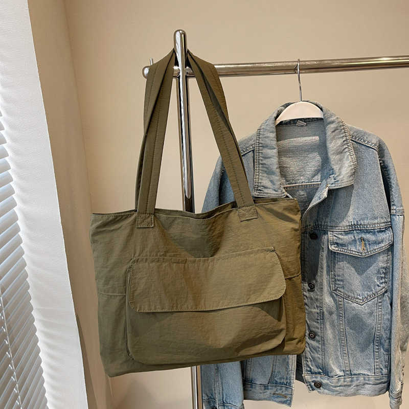 Spring large capacity canvas artistic style 2024 solid color trendy casual simple and lightweight hand-held commuting shoulder tote bag 241231