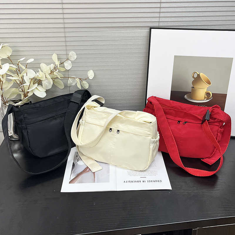 Large capacity single shoulder tote casual waterproof and stylish simple nylon fabric solid color lightweight sports dumpling tote women's bag 24