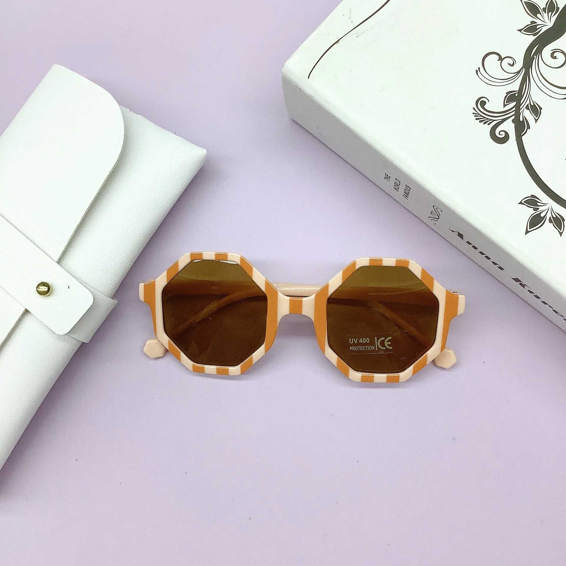 Sunglasses Fashionable PC frame childrens sunglasses wrapped with lovely concave shape anti-UV childrens sunglasses tide