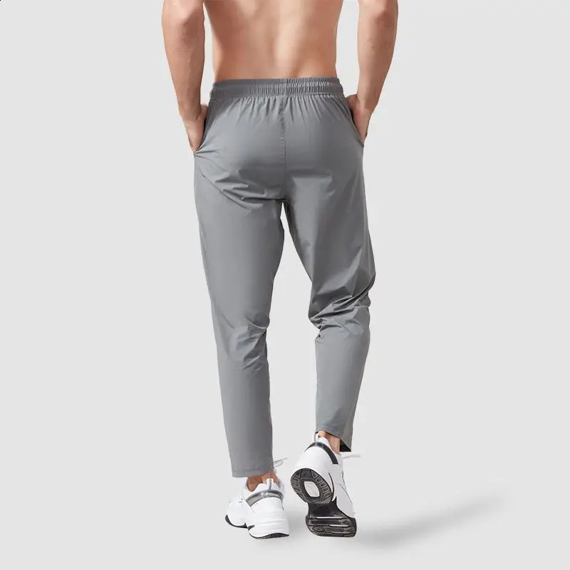 Spring and autumn mens track and field clothes sports pants loose elastic waist fast drying training solid runner breathable casual straight pants 241
