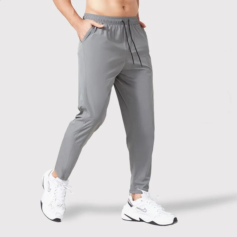 Spring and autumn mens track and field clothes sports pants loose elastic waist fast drying training solid runner breathable casual straight pants 241
