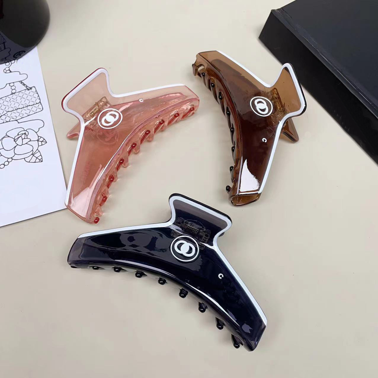 Elegant Hair Clips with Iconic Emblem High -Quality Acrylic Material Hair Clamps Stylish and Functional - Available in Multiple Colors.