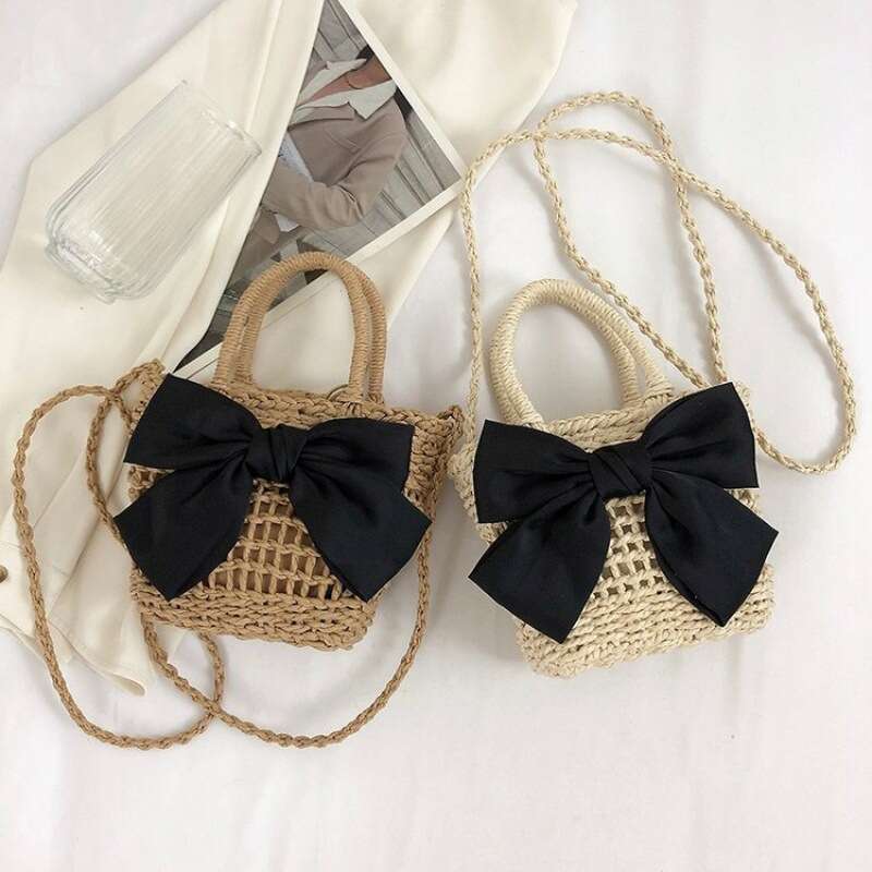 Handheld French niche 2024 new cute bow design sense grass woven beach bucket bag for women