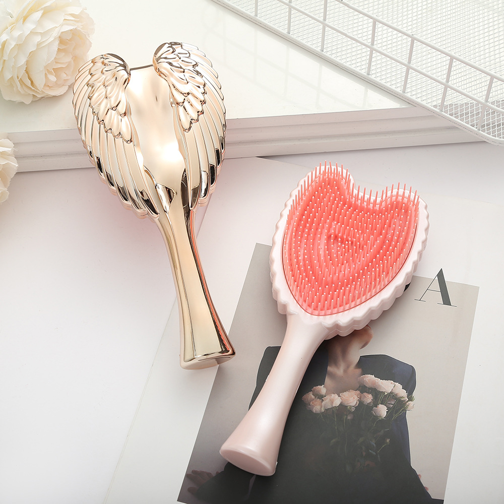 Trendy Minimalistic Hair Brush Featuring Angel Wings - Elegant Solid Colored Combing Tool for Ladies