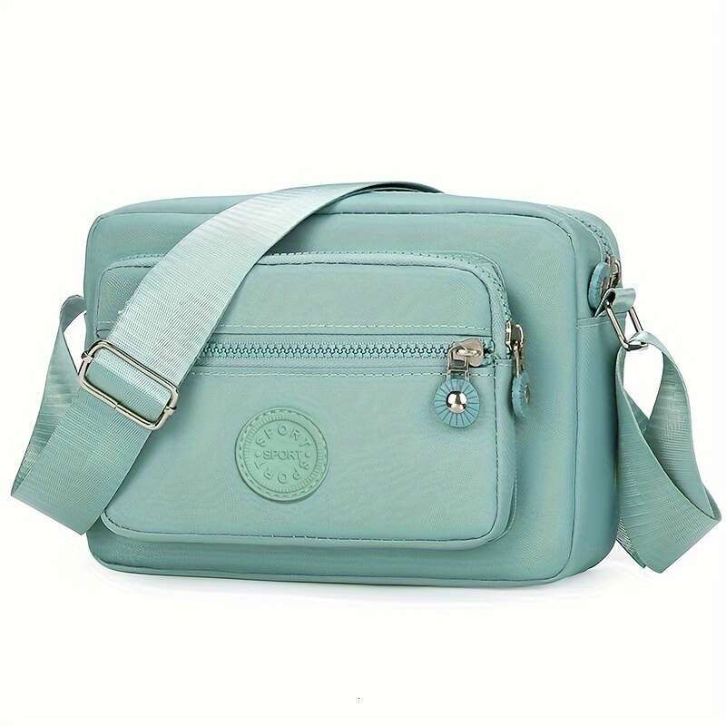Chic Lightweight Nylon Crossbody Bag for Women - Adjustable Strap, Solid Color with Tassel Accent, Zip Closure