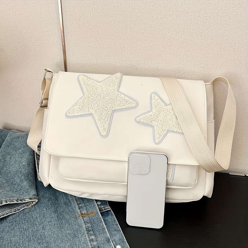 Casual nylon crossbody messenger with star decoration, tassel details, lightweight adjustable straps, zipper closure, and quilted polyester lining - u