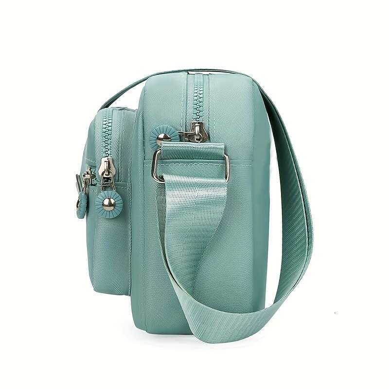 Chic Lightweight Nylon Crossbody Bag for Women - Adjustable Strap, Solid Color with Tassel Accent, Zip Closure