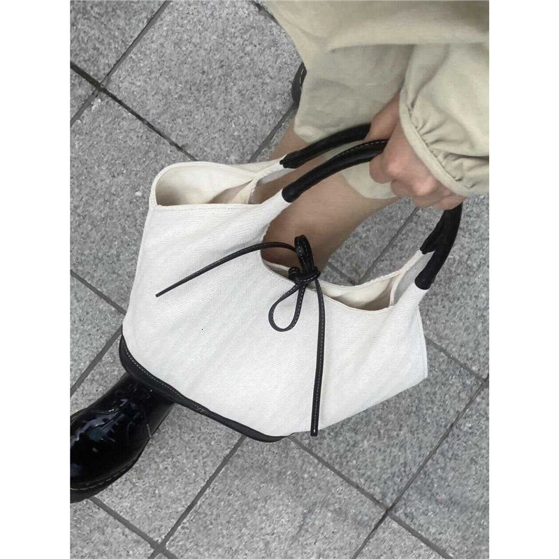 Designer's niche black white patchwork canvas tote bag, fashionable new style, large capacity and versatile commuting handbag, shoulder bag for w