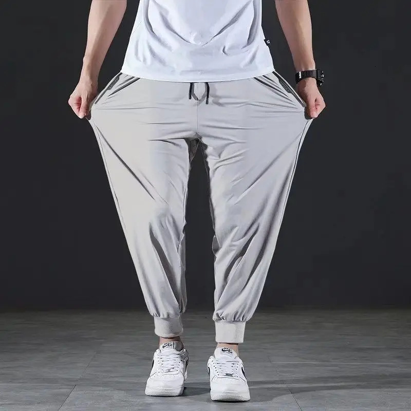 Summer Quick-drying Ice Silk Casual Pants Mens Ultra-thin Elastic Nine-point Pants Loose Drape Solid Beam Feet Pants 7XL 240422