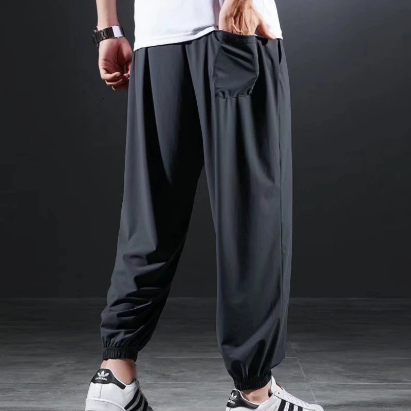 Summer Quick-drying Ice Silk Casual Pants Mens Ultra-thin Elastic Nine-point Pants Loose Drape Solid Beam Feet Pants 7XL 240422