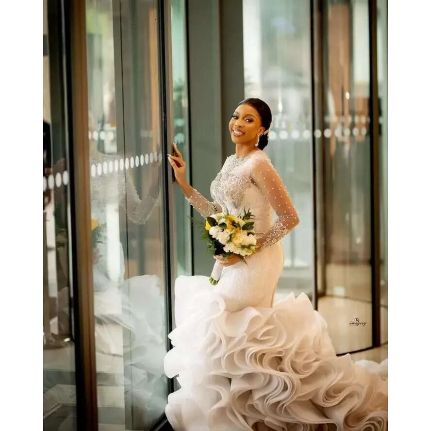 Plus Size Arabic Lace Crystals Urious Wedding Dresses Aso Ebi Sheer Neck Long Sleeves Pearls Beaded Tiers Ruffles Bridal Gowns
