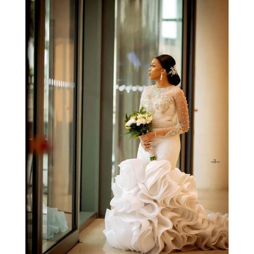 Plus Size Arabic Lace Crystals Urious Wedding Dresses Aso Ebi Sheer Neck Long Sleeves Pearls Beaded Tiers Ruffles Bridal Gowns