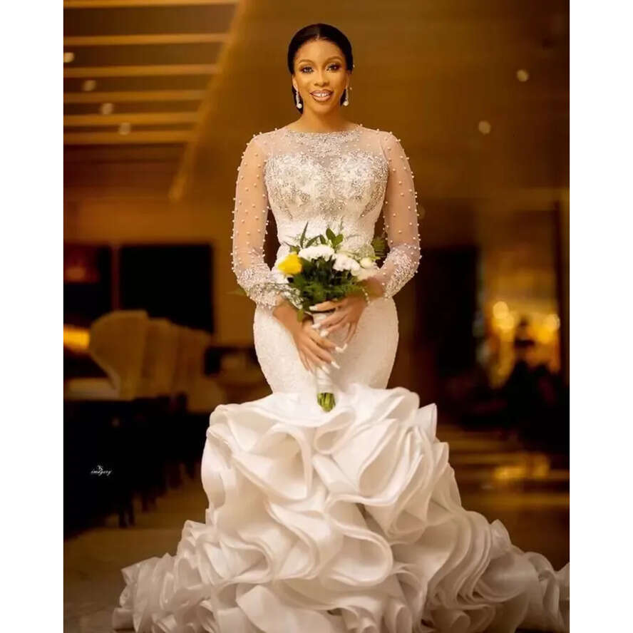 Plus Size Arabic Lace Crystals Urious Wedding Dresses Aso Ebi Sheer Neck Long Sleeves Pearls Beaded Tiers Ruffles Bridal Gowns