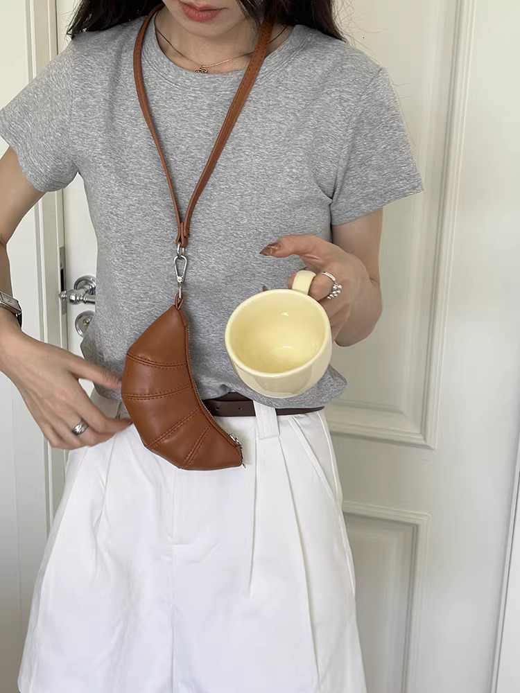 2025S designer neck hanging small change key cute cow horn niche mini bag concave shape crossbody lipstick headphone bag