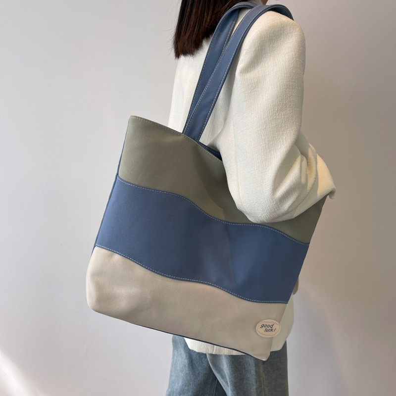 2025 new Women's new textured tri color spliced hand-held canvas with large capacity women's tote shoulder bag