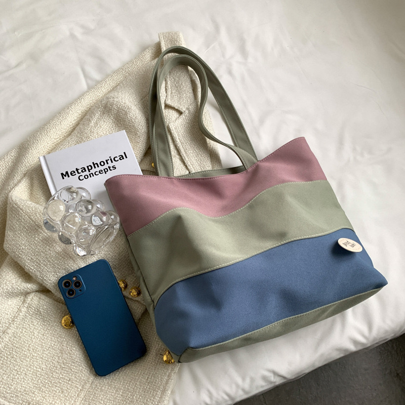 2025 new Women's new textured tri color spliced hand-held canvas with large capacity women's tote shoulder bag