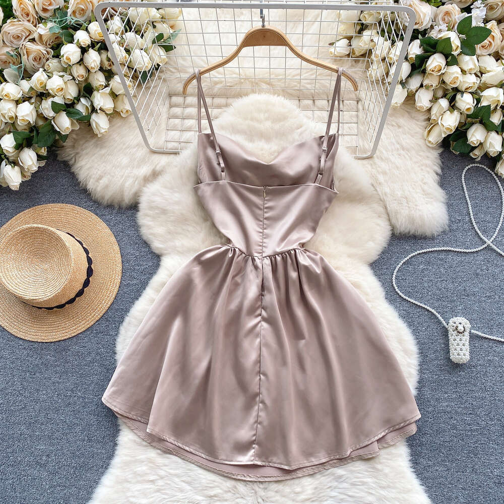 Light luxury and high-end satin dress for women with a fake design. Two slim fitting short A-line skirt and sexy suspender dress