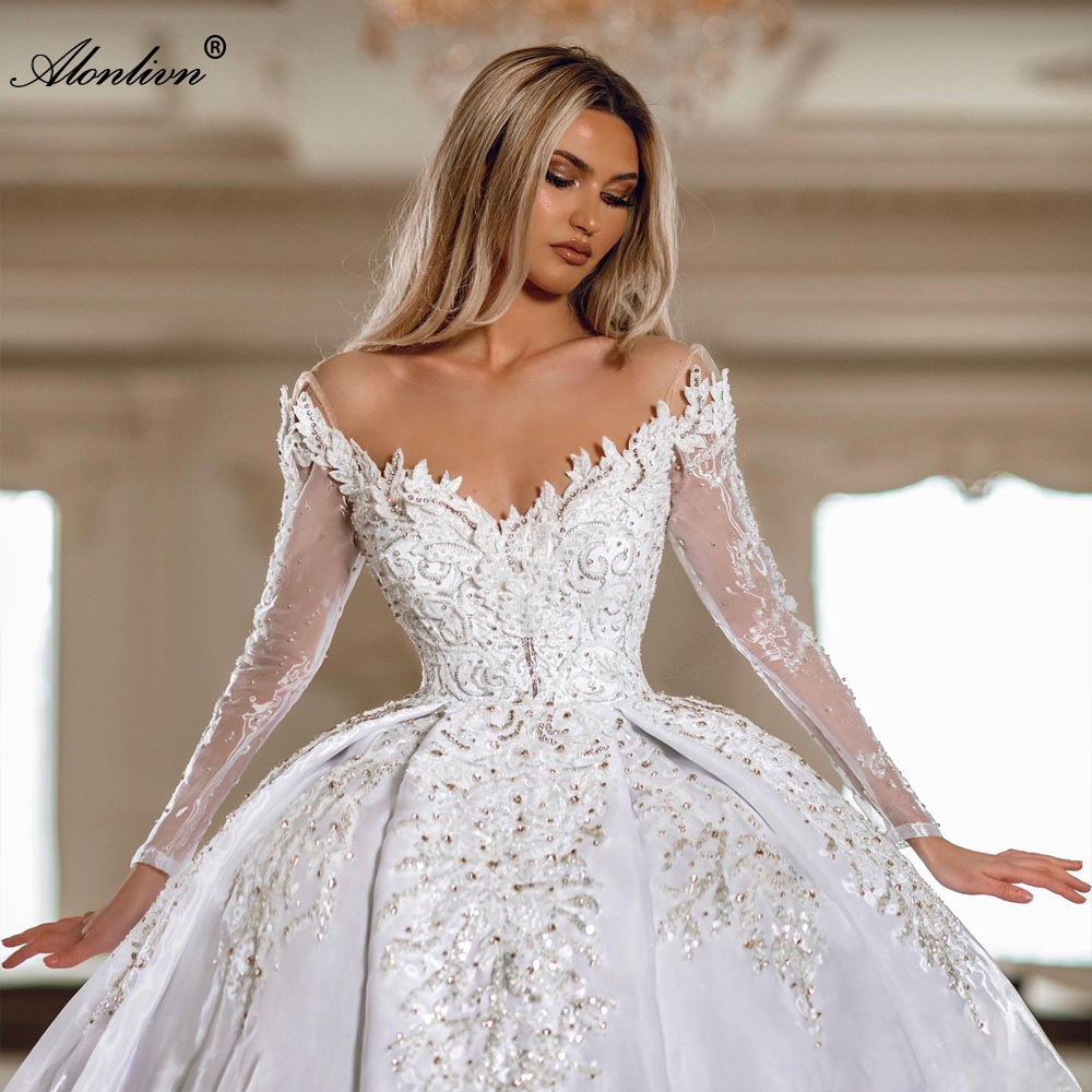 2024 Stunning Lace Illusion V-Neck Ball Gown Wedding Dress Delicate Beaed Pearls Bling Appliques Lace Full Sleeves Bridal Gowns 2024