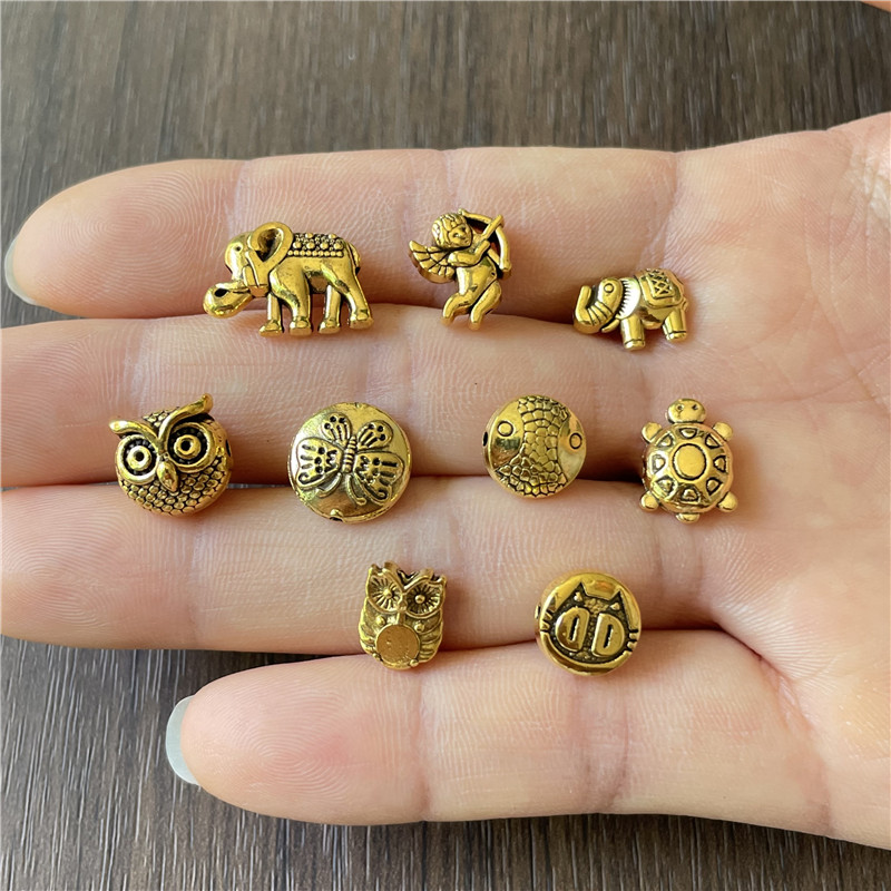 JunKang 90pcs 9 kinds animal series owl fish turtle baby elephant angel butterfly perforated beads DIY bracelet necklace gasket