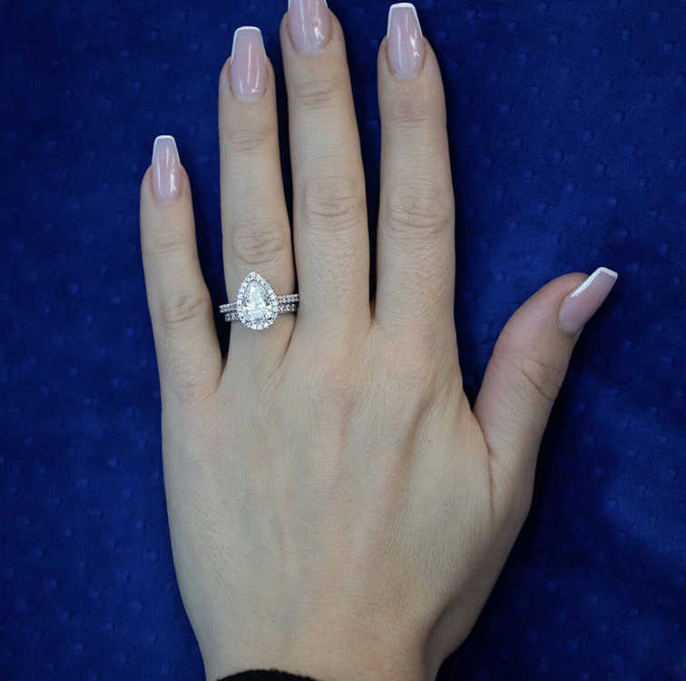 Platinum 3.46ctw Pear and Round Brilliant Cut Moissanite Diamond Ring