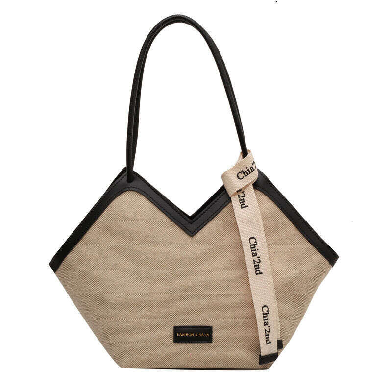 Wooden mouth large capacity versatile for women's outings, 2023 high-end canvas tote bag, commuting and class trend