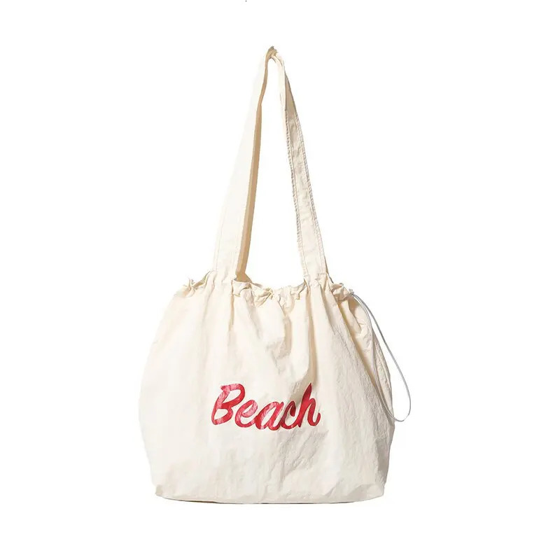 Womens Korean version letter printed canvas shoulder bag casual version commuting drawstring large capacity bag 241008