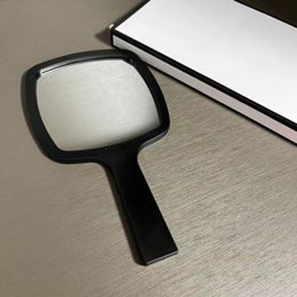 Designer holding makeup mirror black and white classic style mirror women's travel portable small mirror essential makeup mirror in bag