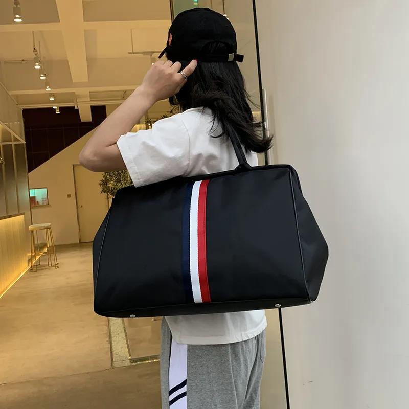 New designer travel bag large women's handbag men's waterproof portable foldable neutral wholesale travel package striped cushion