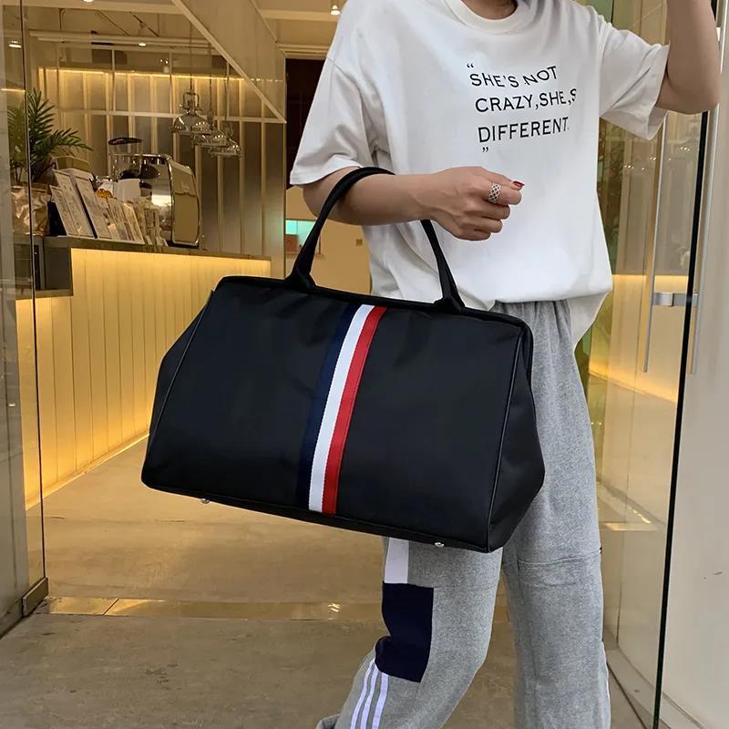 New designer travel bag large women's handbag men's waterproof portable foldable neutral wholesale travel package striped cushion