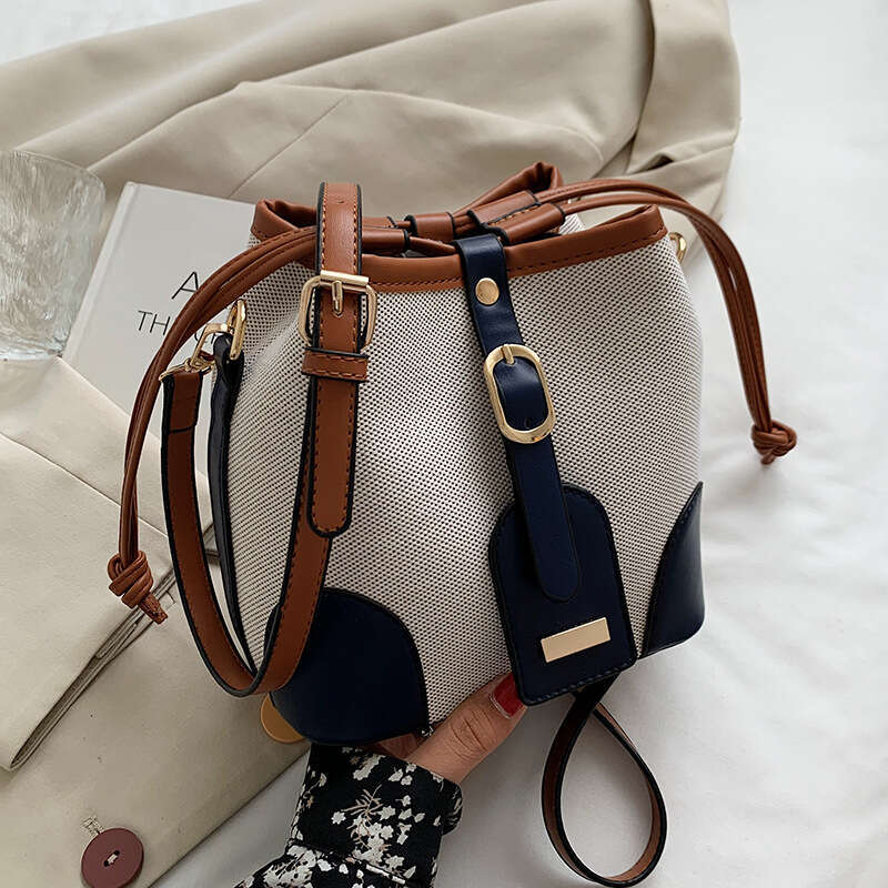 High end canvas contrasting color crossbody bucket for women's spring and summer 2024 new trend, niche design, versatile shoulder bag
