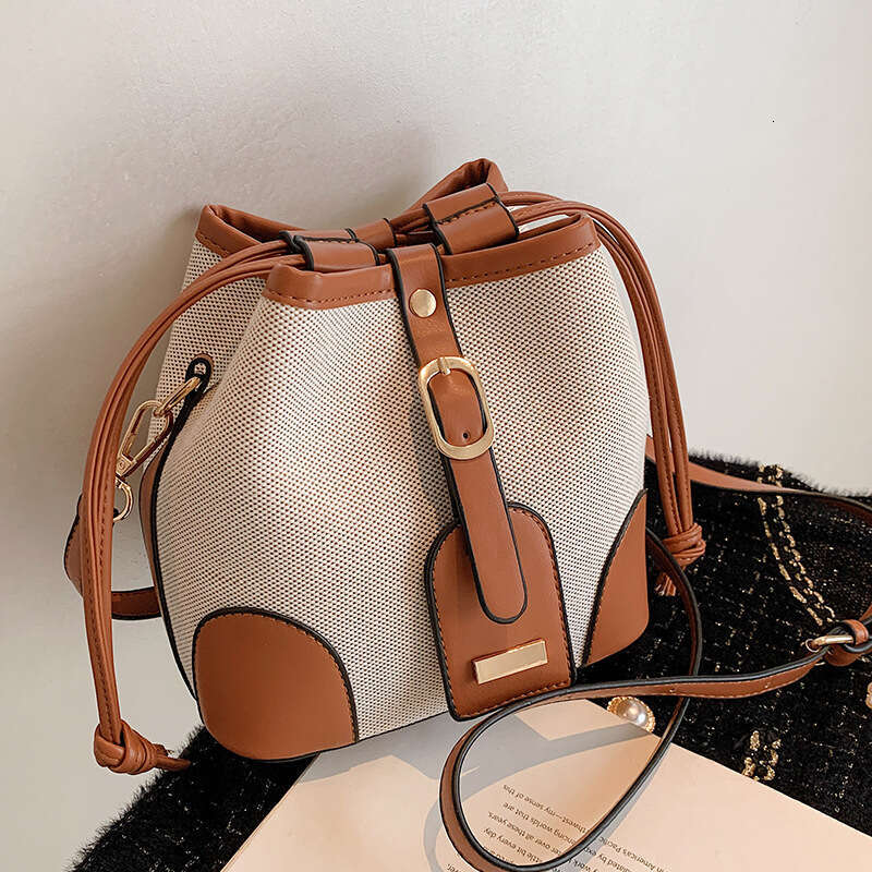 High end canvas contrasting color crossbody bucket for women's spring and summer 2024 new trend, niche design, versatile shoulder bag