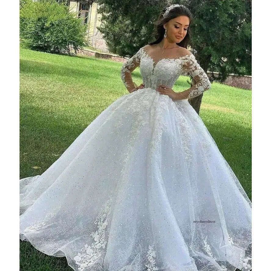 2024 A E Wedding Dresses Jewel Neck Long Sleeves Lace Appliques Crystal Beads Illusion 3D Ral Wers Sequins Sweep Train Sexy Bridal Gowns 0513