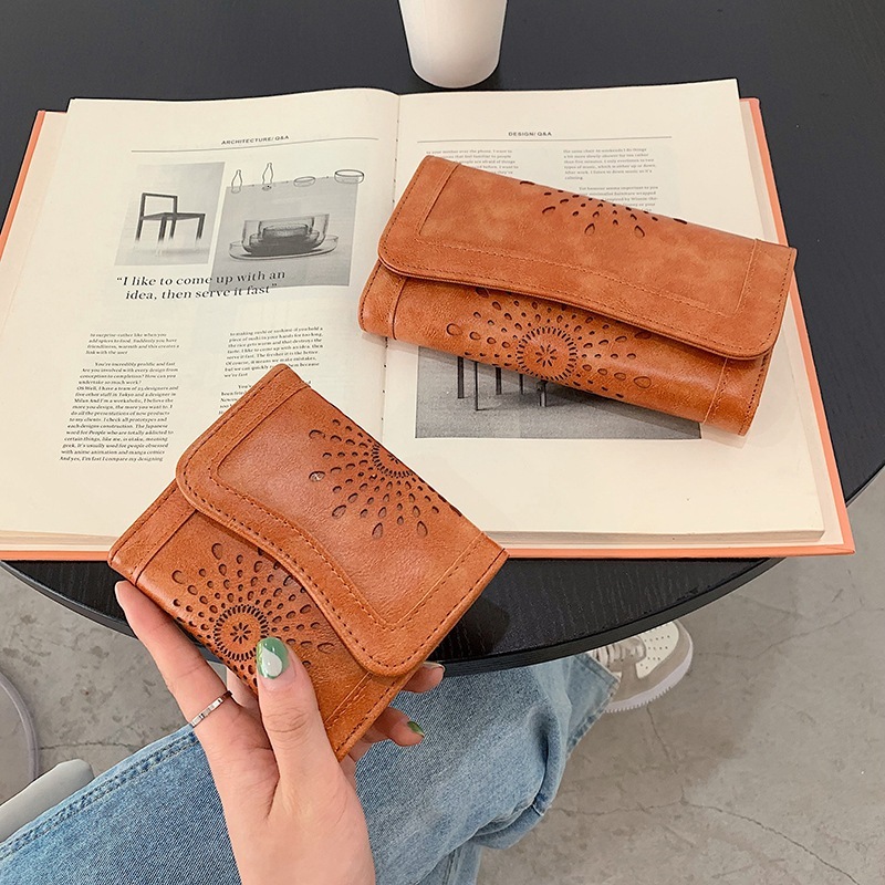 New designer oil wax PU handheld fashionable hollowed out women's mid to long money bag