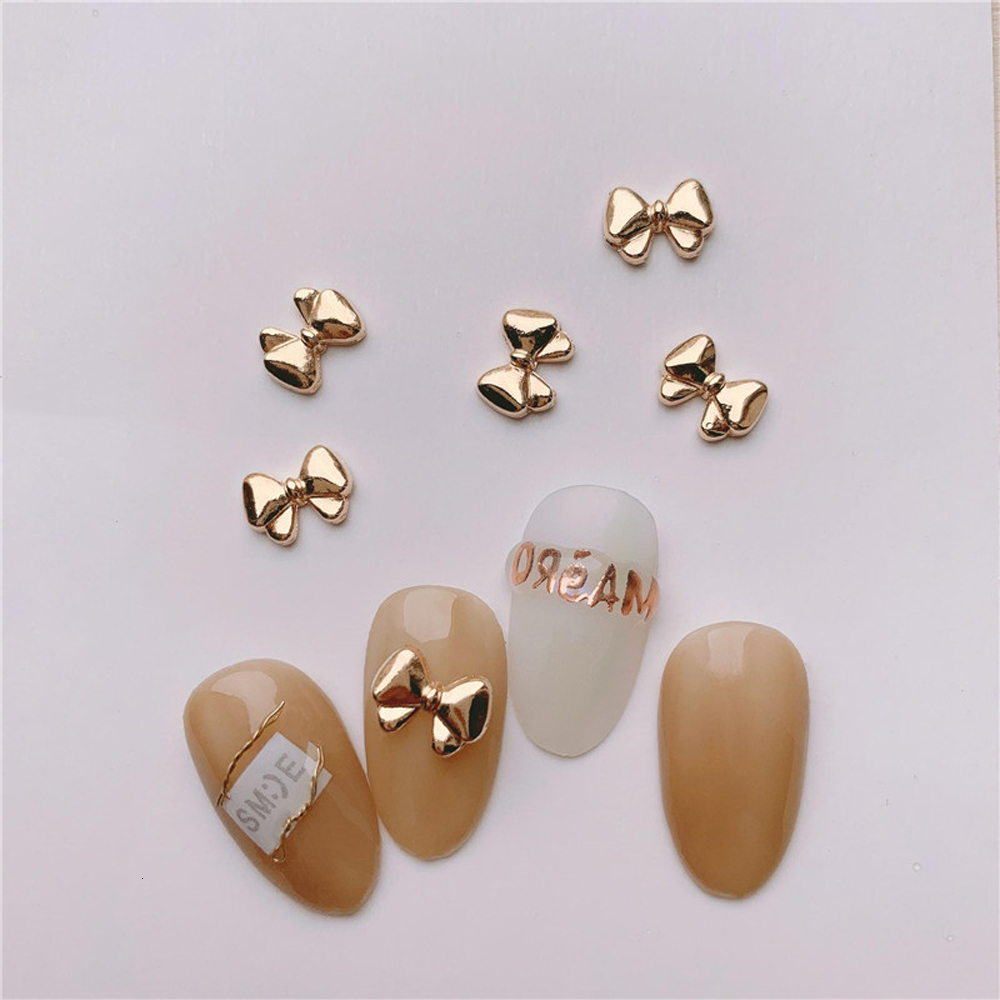 Nail Art Decorations 100 Mini Cute Bow Nail Decoration Vintage Gold Chrome Bow Alloy Charm 3D Bow Parts Finger Decoration 230718