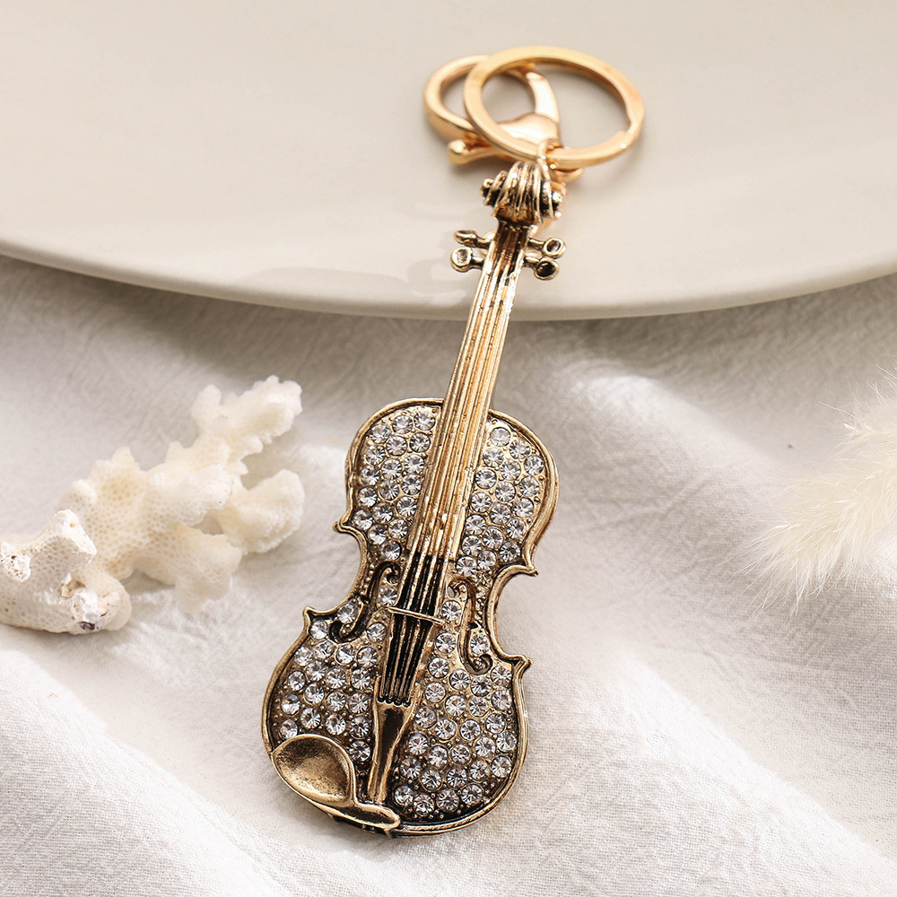 Wholesale Rhinestone Guitar Shape Small Gift Package Pendant Alloy Tarnish Keychain Ornaments Little Creative Gifts
Wholesale Rhinestone Guitar Shape Small Gift Package Pendant Alloy Tarnish Keychain Ornaments Little Creative Gifts