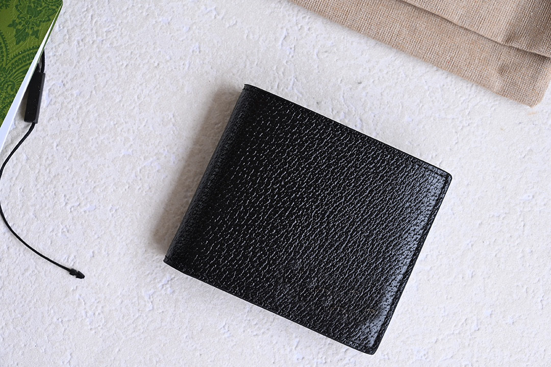This 2013 double fold wallet features a black leather wallet with gold accents. Inside, there are 8 card compartments and 2 bill compartments
This 2013 double fold wallet features a black leather wallet with gold accents. Inside, there are 8 card compartments and 2 bill compartments