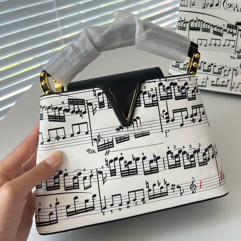 20/27cm Women Capucines BB Designer Shoulder Bags Top Handle Tote Two-Tone Music Score Musical Note Gold Metal Hardware Crossbody Leather Strap Large Capacity Purse, 20x13.5cm
20/27cm Women Capucines BB Designer Shoulder Bags Top Handle Tote Two-Tone Music Score Musical Note Gold Metal Hardware Crossbody Leather Strap Large Capacity Purse, 20x13.5cm