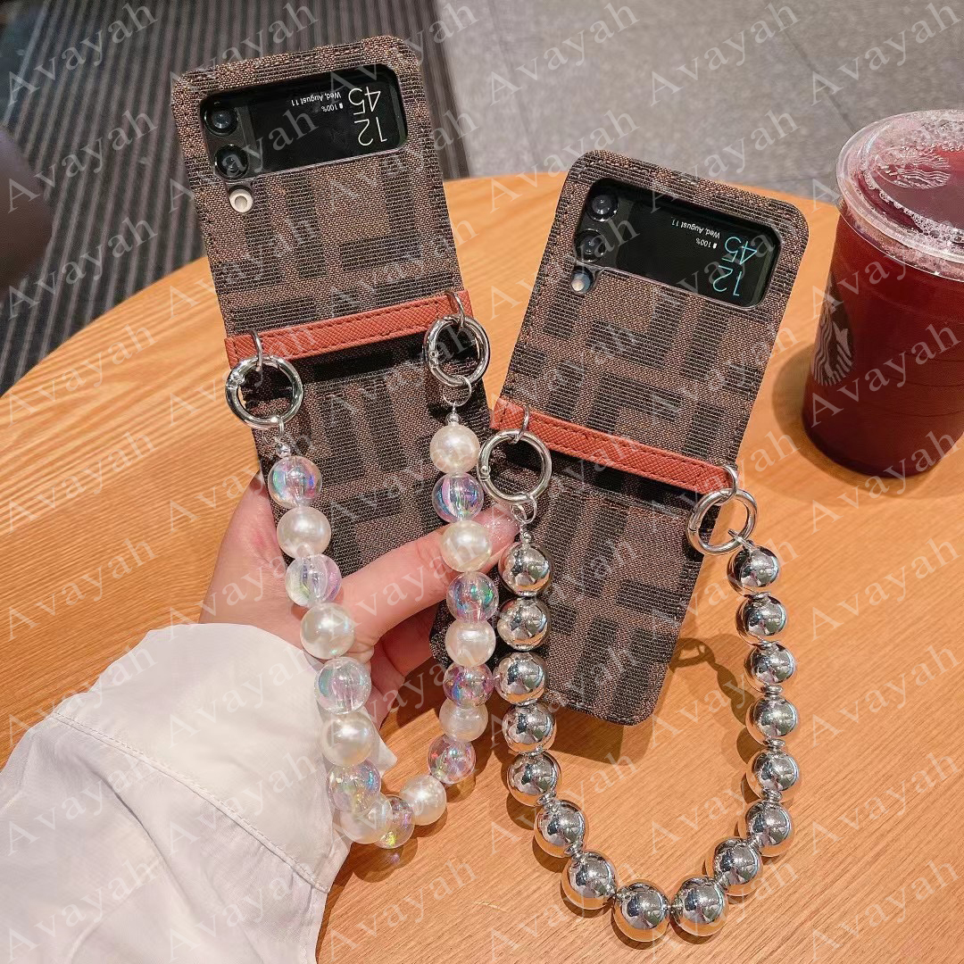 Luxury Letter Phone Cases For Samsung Z Flip 2 3 4 Protection Samrtphone Case Cover Fiber Cloth Skin Designer Cover Flip2 Flip3 Flip4 With Portable Pearl Chain, #1
Luxury Letter Phone Cases For Samsung Z Flip 2 3 4 Protection Samrtphone Case Cover Fiber Cloth Skin Designer Cover Flip2 Flip3 Flip4 With Portable Pearl Chain, #1