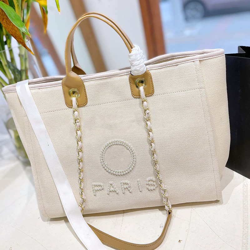 Womens Pearl Letter Canvas Beach Shopping Bags Deauville Clutch With Chain Top Handle Totes Gold Metal Chain Shoulder Pocket Large Capacity Handbags 37X29CM, Box
Womens Pearl Letter Canvas Beach Shopping Bags Deauville Clutch With Chain Top Handle Totes Gold Metal Chain Shoulder Pocket Large Capacity Handbags 37X29CM, Box
