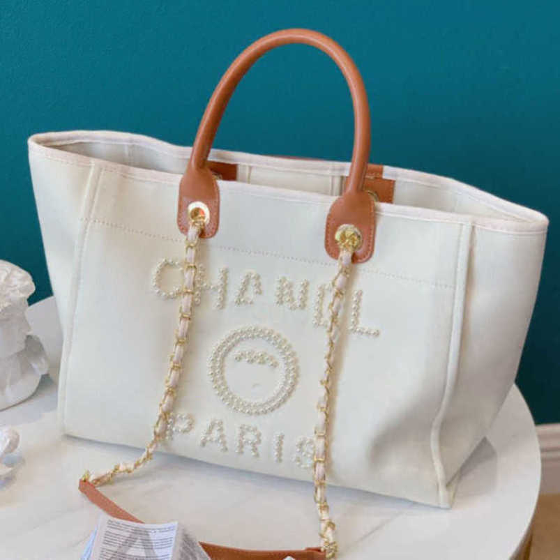 Fashion Women's Luxury Evening Bags Ch Brand Canvas Handbag Classic Pearl Beach Hand Bag Designer Female Large Backpack Small Packs Portable Shopping Handbags 3jkc
Fashion Women's Luxury Evening Bags Ch Brand Canvas Handbag Classic Pearl Beach Hand Bag Designer Female Large Backpack Small Packs Portable Shopping Handbags 3jkc