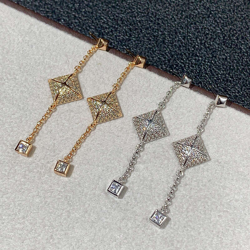 DHcollections Stylish V - Gold Women's Cross - Square Rivet Pendant Chain Earrings with Tassels. These V - Gold earrings feature a unique geometr