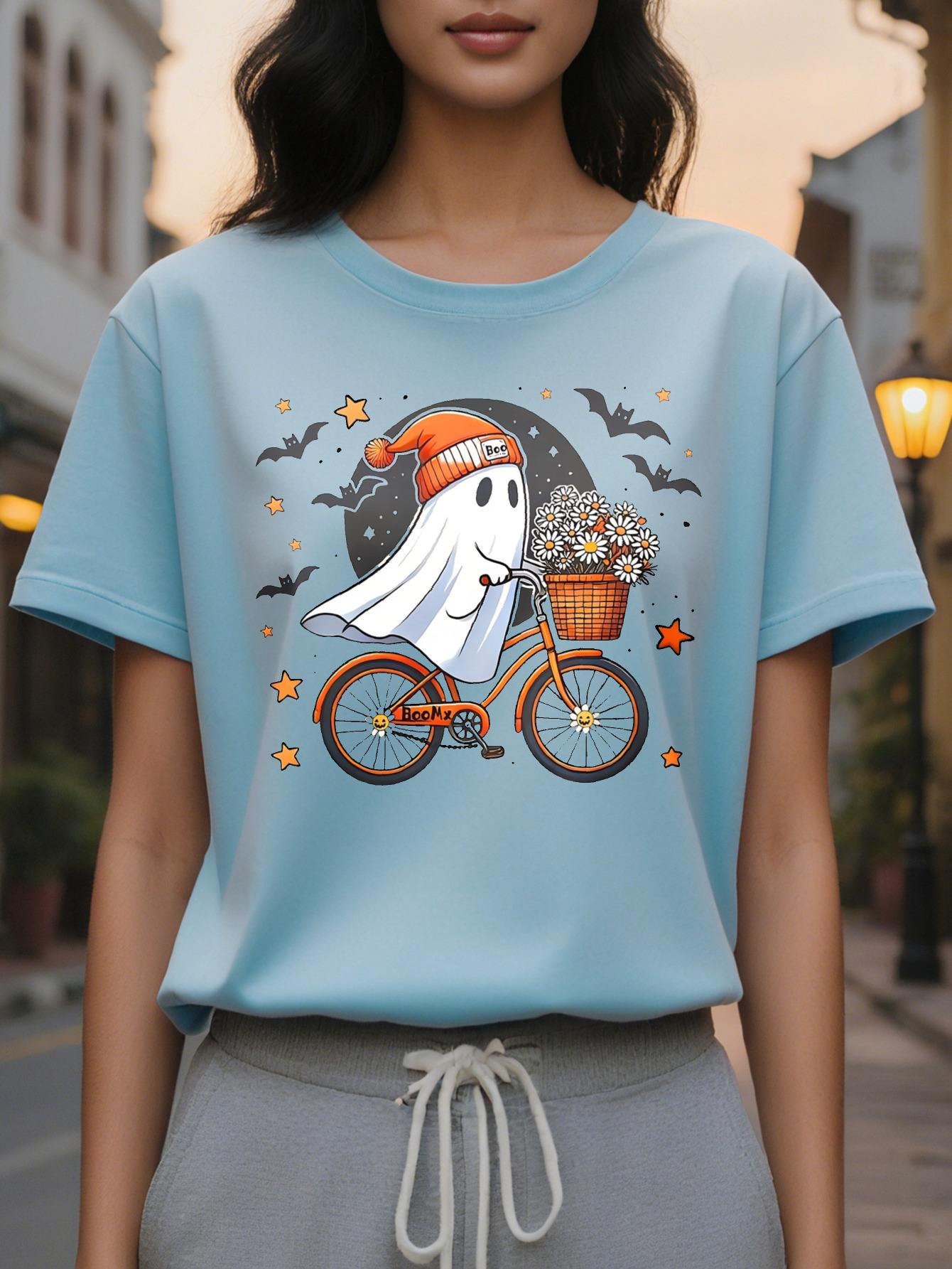 Women Graphic Tee Cute Ghost Riding Bike with Floral Basket Black Orange Design Casual Round Neck T-Shirt for