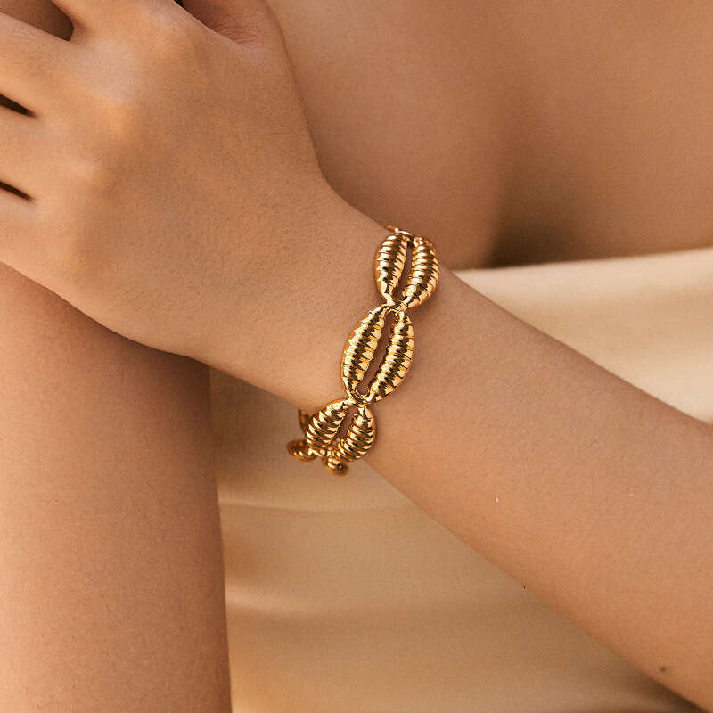 DH collections Vintage - style 18K Gold - plated Copper Bracelet with Shell Design. This bracelet in a geometric shape offers a retro and laid - back 